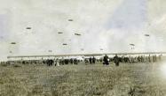 Aerial advertising kites flying near the 1909 Vanderbilt Cup Race grandstand